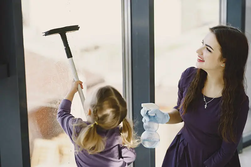 Girls cleaning window