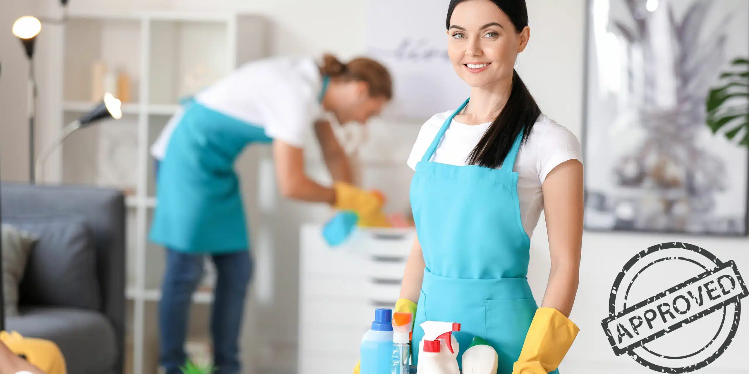 Cleaning ladies, one holding a bucket with cleaning materials and one dusting a cabinet.